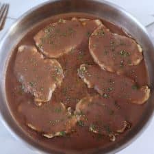 Chicken steaks with coffee sauce on a frying pan