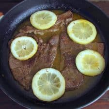 Steaks with lemon and honey on a frying pan