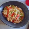 Turkey steaks with peppers and rice on a dish bowl