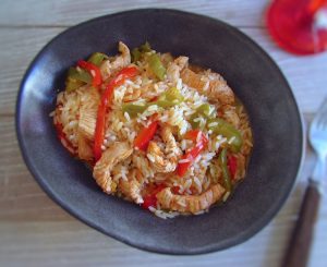 Turkey steaks with peppers and rice on a dish bowl