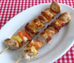Chicken, shrimp and pineapple kebabs on a platter