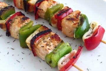 Salmon and squids kebabs on a plate