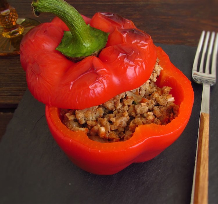 Roasted stuffed peppers with meat on a table