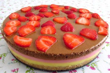 Vanilla and strawberry semifreddo topped with chocolate mousse on a plate