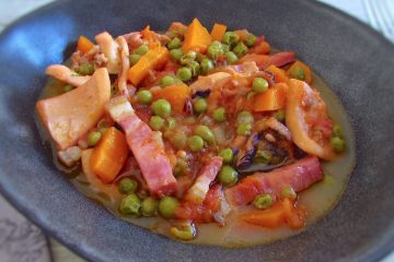 Cuttlefish with peas and carrots on a dish bowl