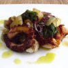 Octopus in the oven with chestnuts on a plate