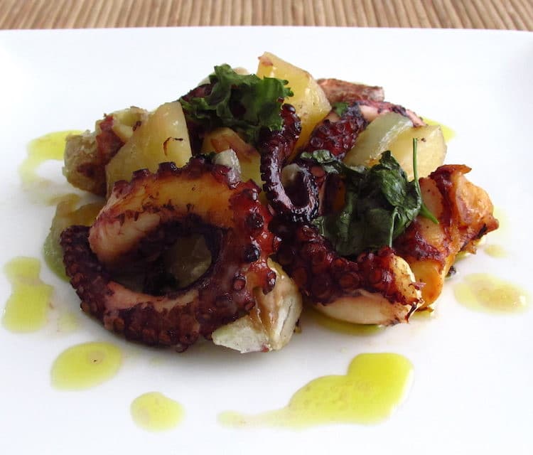 Octopus in the oven with chestnuts on a plate