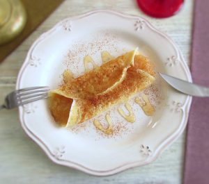 Crepe stuffed with apple jam on a plate