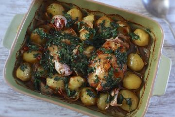 Baked hake with coriander on a baking dish