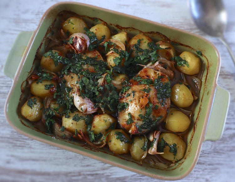 Baked hake with coriander on a baking dish
