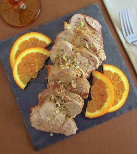 Slices of pork tenderloin with orange