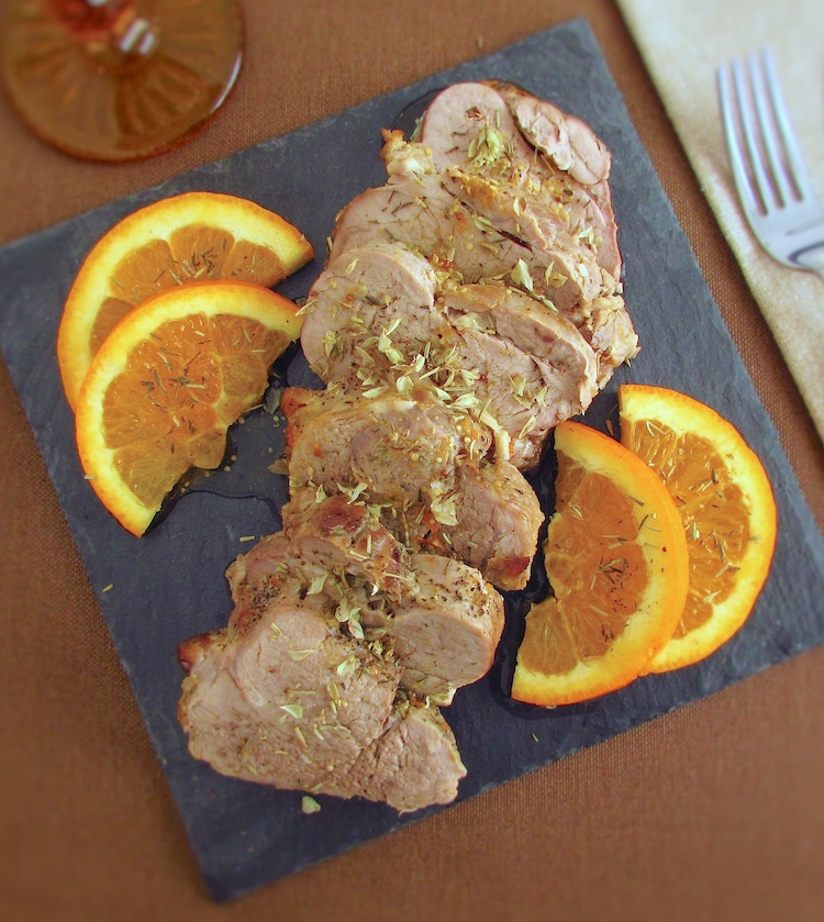 Slices of baked pork tenderloin with orange