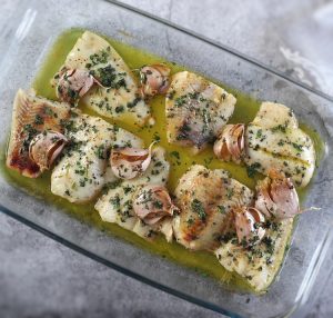 Baked hake fillets on a glass baking dish
