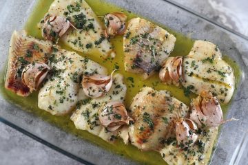 Baked hake fillets on a glass baking dish