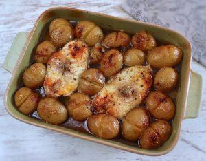 Baked grouper with potatoes on a baking dish