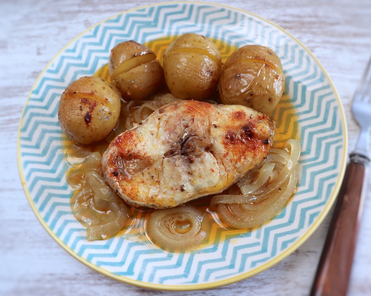 Baked grouper with potatoes on a plate
