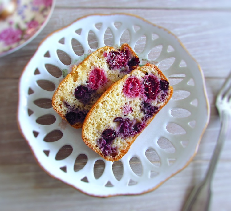 Slices of berry yogurt loaf cake on a plate