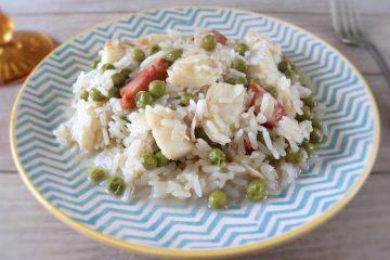 Rice with cod and peas on a plate