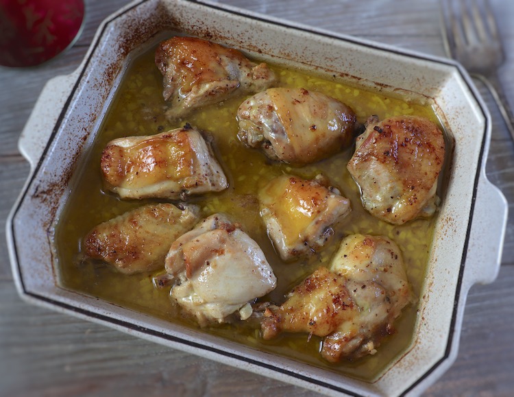 Baked chicken with homemade sauce on a baking dish