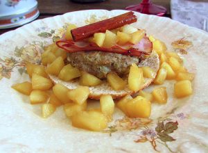 Burger with apple and bacon on a plate