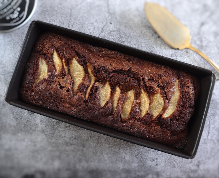 Cocoa pear cake on a loaf tin