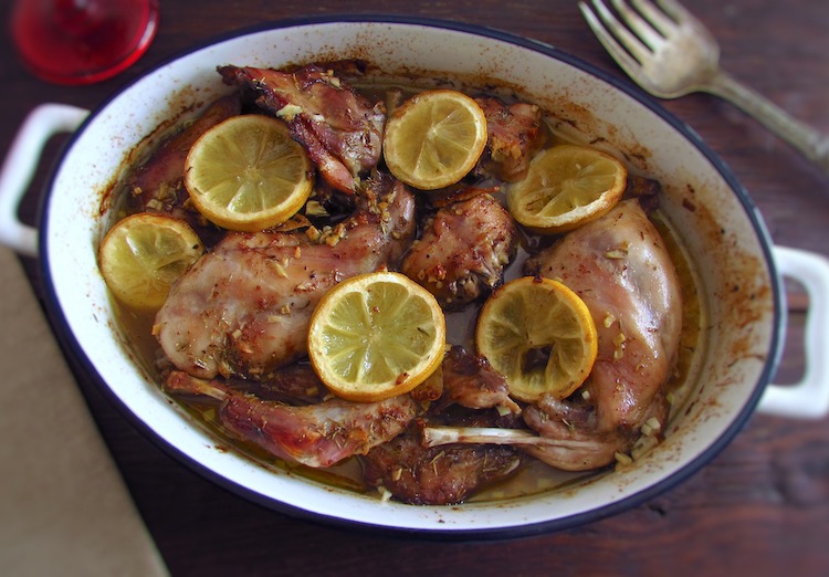 Rabbit in the oven with lemon on a baking dish