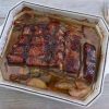 Baked pork ribs with apple on a baking dish