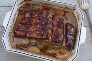 Pork ribs with apple in the oven on a baking dish