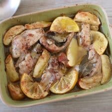 Baked rabbit with apple and lemon on a baking dish