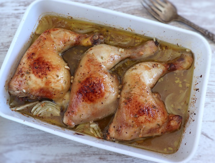 Chicken legs in the oven with lemon and honey on a baking dish