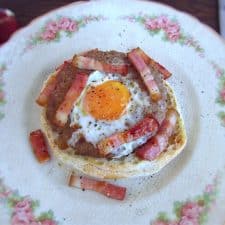 Burgers with egg and bacon on a plate