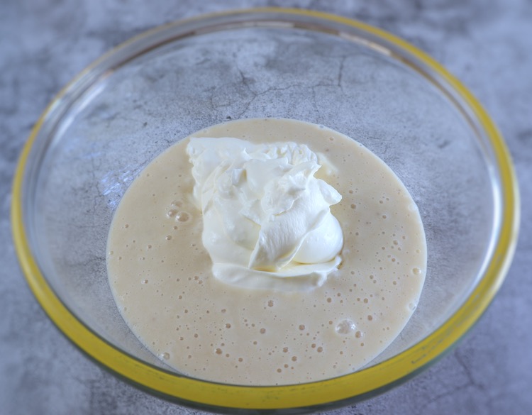 Banana cream and whipped cream on a large glass bowl
