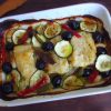 Cod loins in the oven with olives on a baking dish