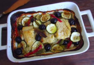 Roasted cod loins with olives with olives on a baking dish