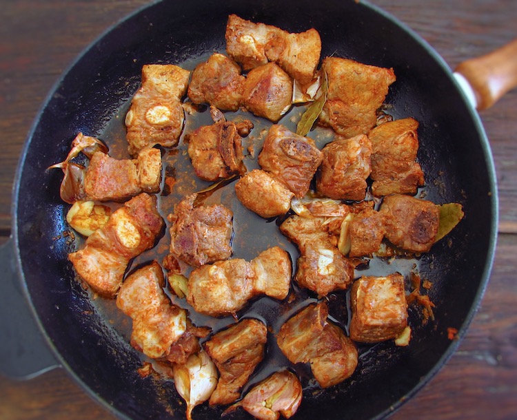 Fried pork ribs on a frying pan