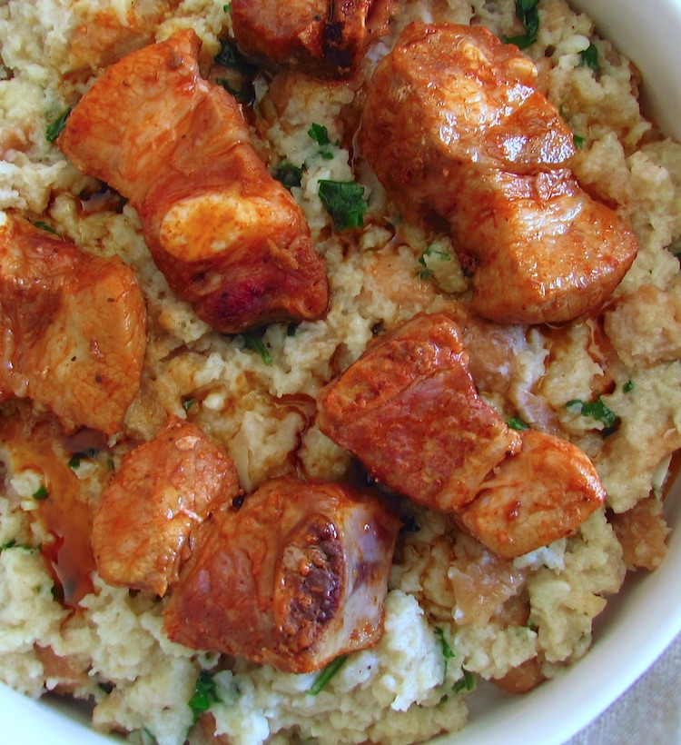Portuguese migas (crumbs) with pork ribs on a dish bowl