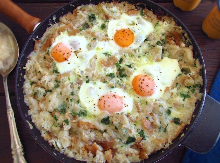 Portuguese migas (crumbs) with poached eggs in a frying pan