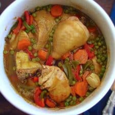 Chicken stew with peas, carrot and peppers in a pot