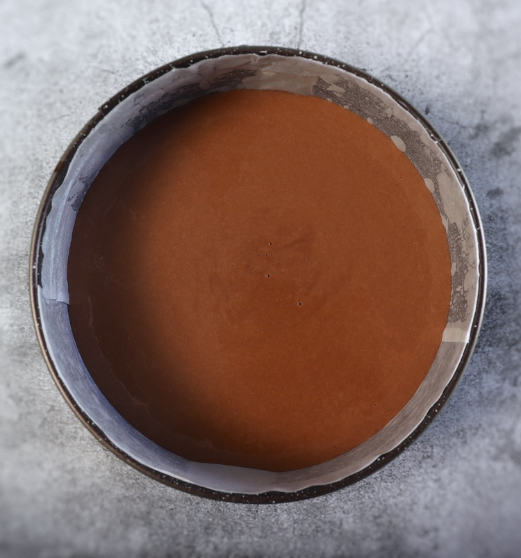 Dough of chocolate coffee cake on a round cake pan
