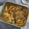 Baked chicken with lemon and spices on a baking dish