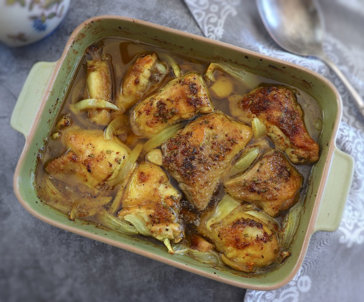 Baked chicken with lemon and spices on a baking dish