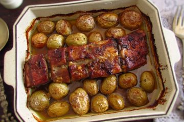 Pork ribs in the oven with honey and mustard on a baking dish