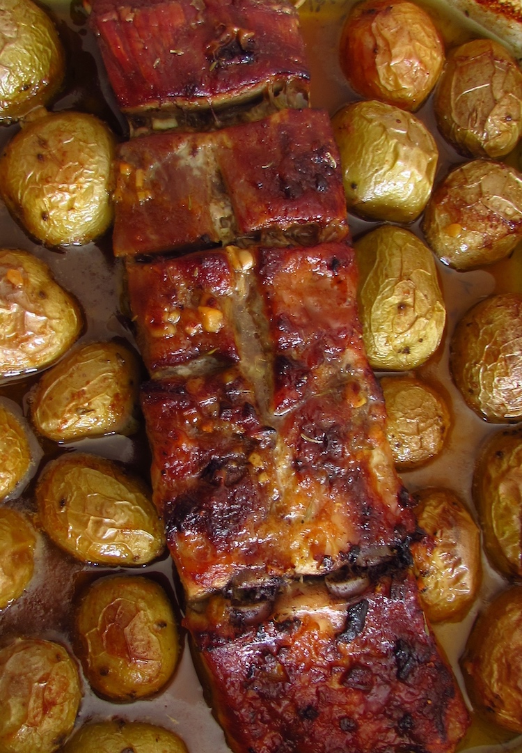 Roasted pork ribs with honey and mustard on a baking dish