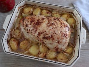 Baked turkey loin with lemon and cinnamon on a baking dish