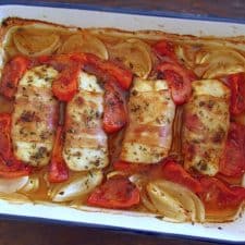 Hake loins with bacon on a baking dish