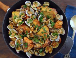 Fried chicken with clams on a frying pan