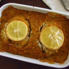 Baked ling fish with cornbread crust on a baking dish