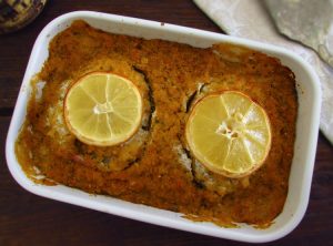 Baked ling fish with cornbread crust on a baking dish