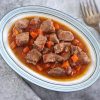 Pork stew with carrot on a platter