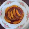 Beef medallions with caramelized peach on a plate